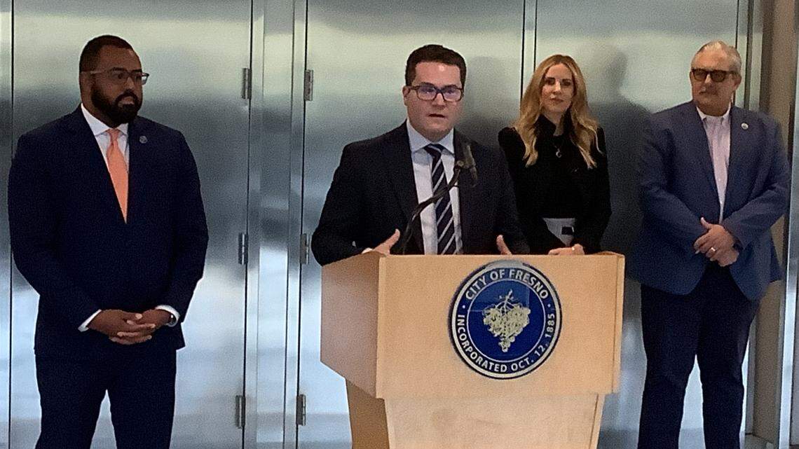 Fresno City Councilmember Nelson Esparza, left, looks on as Will Oliver, president/CEO of the Fresno County Economic Development Corporation, discusses proposed economic incentives for companies to come to Fresno to manufacture semiconductors at a press conference on Tuesday, Oct. 31, 2023. Also in attendance are Genelle Taylor Kumpe, CEO of the San Joaquin Valley Manufacturing Alliance, second from right, and Fresno Chamber of Commerce president/CEO Scott Miller, far right.