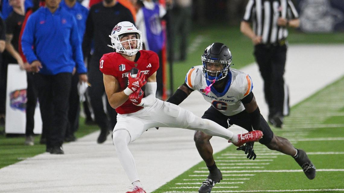 Fresno State wideout Mac Dalena, left, makes the catch with Boise State’s Jaylen Clark in coverage in the Bulldogs’ 37-30 victory Saturday, Nov. 4, 2023 in Fresno.