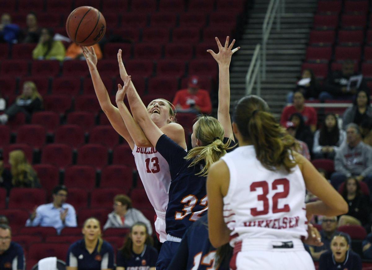 Fresno State’s Amiee Book, left, shoots over Fresno Pacific’s Sara Lundqvist Monday, Nov. 7, 2022 in Fresno.