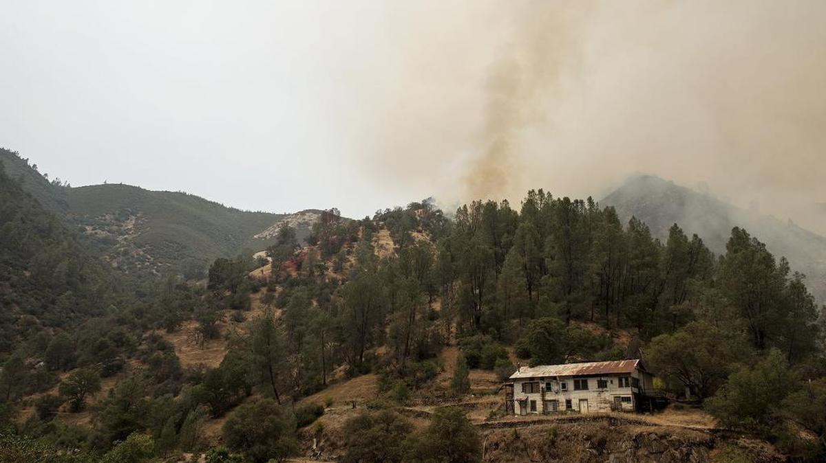 The Ferguson fire continues to burn on the north side of Highway 140 and the Merced River in Mariposa County, Calif., Saturday, July 21, 2018. The fire was steadily growing Saturday after two more firefighters were injured while battling the flames in blazing summer heat to protect mountain communities in the Sierra Nevada. The Ferguson fire was churning northward within Sierra National Forest, sending up smoke that obscured valley views in the park. Yosemite remained open, but one of its scenic routes, Glacier Point Road, was closed to stage firefighters. (Andrew Kuhn/The Merced Sun-Star via AP)