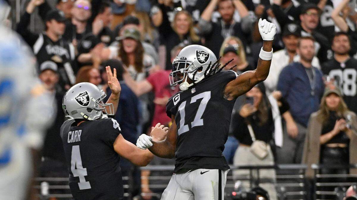 Las Vegas Raiders wide receiver Davante Adams celebrates his touchdown reception with quarterback Derek Carr during the second half of an NFL game, Sunday, Dec. 4, 2022, in Las Vegas.