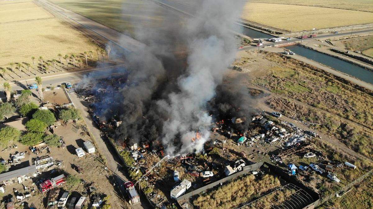 Firefighters battled a fire involving four mobile homes and 40 vehicles Saturday, Oct. 1, 2022, along the Fresno/Merced county line.