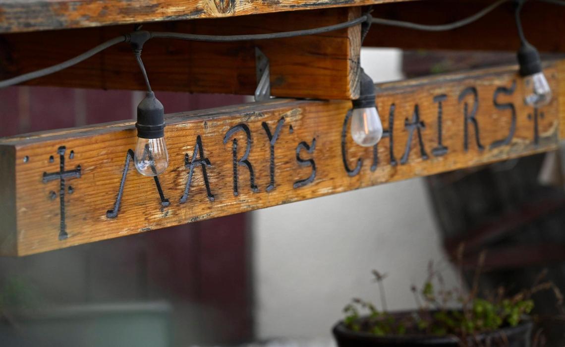A large wooden chair in Robert Sandoval’s front yard has his wife Mary Ann’s name on the front. Robert said he constructed the chair in 2021 to memorialize his wife who died in a car crash in 2015. Photographed Oct. 16, 2024 in Fresno