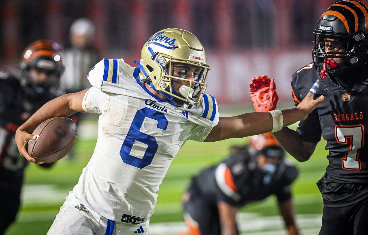 Clovis running back James Curoso stiff-arms his way downfield against Central East in their game at Koligian Stadium in Fresno on Friday, Oct. 24, 2025.
