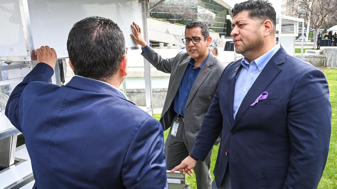 Fresno City council members Miguel Arias, center, and Luis Chavez get information about a new food cart prototype that meets permitting standards from the Fresno County Health Department during an unveiling event at Fresno City Hall on Thursday, March 9, 2023.