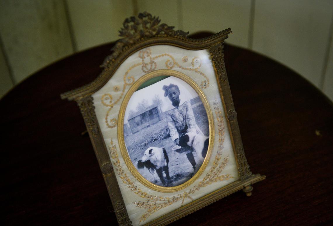 A photo of Allensworth resident Irene Phillips with a couple of dogs sits on a table in a home at Colonel Allensworth State Historic Park near Earlimart on Thursday, Feb. 7, 2019.