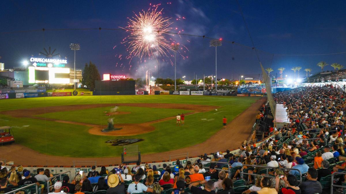A large crowd watches from the stands as a Fourth of July fireworks show begins at Chukchansi Park following a game between the Fresno Grizzlies and Rancho Cucamonga Quakes. The Grizzlies won the game 2-1. There are two more fireworks shows scheduled for Saturday and Sunday’s games.