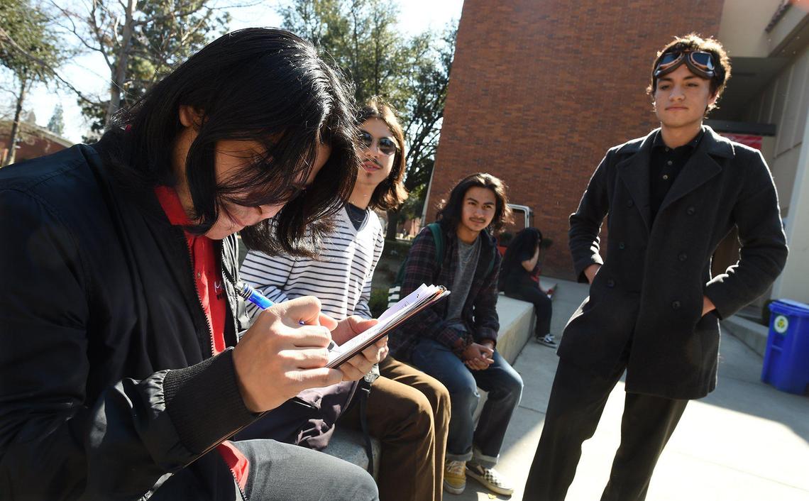 Fresno City College Student Ash Pallares, right, circulates a petition, being signed by FCC student Joshua Hernandez, left, asking the State Center Community College District to save a free bus program, Thursday Feb. 13, 2020. Funds for the program ran out and it’s going to be ending in May if the board doesn’t find other ways to fund the program.