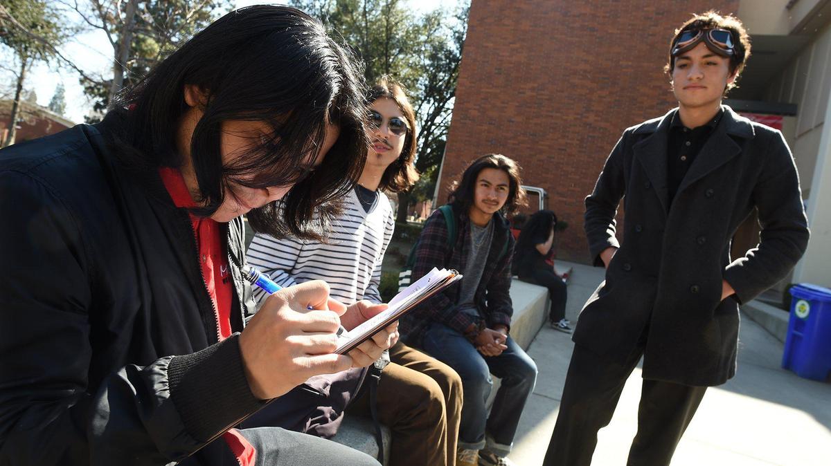 Fresno City College Student Ash Pallares, right, circulates a petition, being signed by FCC student Joshua Hernandez, left, asking the State Center Community College District to save a free bus program, Thursday Feb. 13, 2020. Funds for the program ran out and it’s going to be ending in May if the board doesn’t find other ways to fund the program.