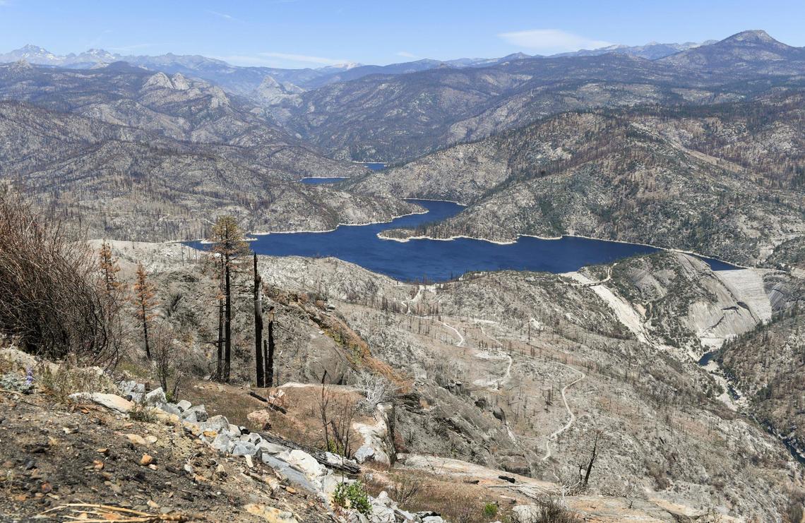 Scorched landscape surrounds Mammoth Pool Reservoir in the Sierra National Forest after being burned in the Creek Fire, viewed from the Mile High Vista on Mammoth Pool Road on Friday, June 11, 2021.