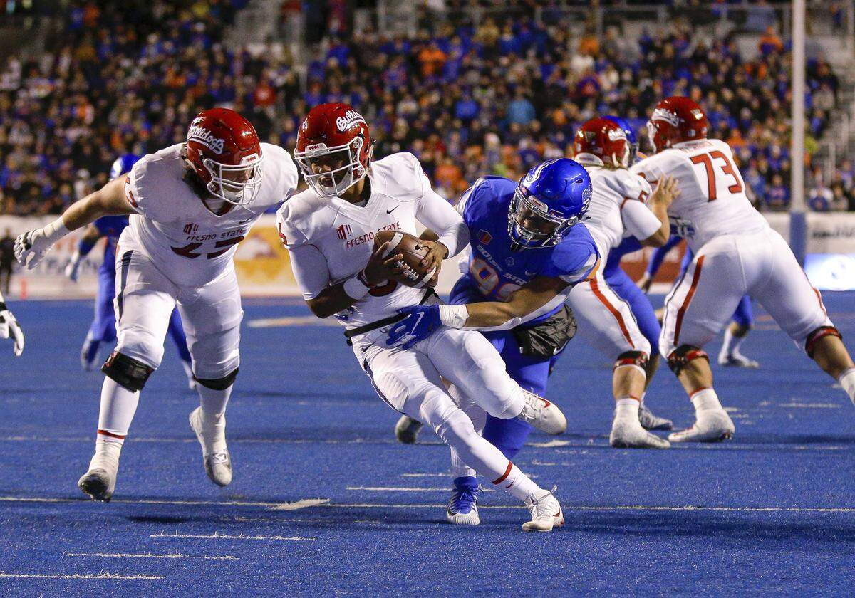 Fresno State quarterback Marcus McMaryion (6) tries to pull away from Boise State’s Curtis Weaver (99) during the Bulldogs’ 24-17 loss at Albertsons Stadium Friday, Nov. 9, 2018, in Boise, Idaho. Weaver sacked McMaryion on the play.