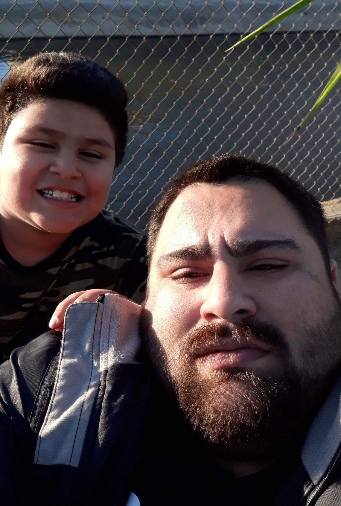 Angel Hernandez, 10, takes a photo with his Dad, Angel. 