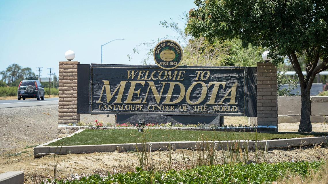 A car drives past a welcome sign on the southern boundary of Mendota on Thursday, June 10, 2021.