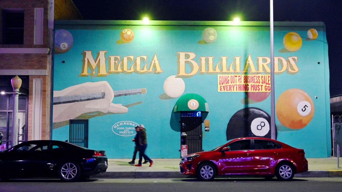 Mecca Billiards is seen at night on Fulton Street in downtown Fresno’s Brewery District, Friday, Feb. 10, 2023. Nanette Stockle, who operated Mecca Billiards with her husband until his death of ALS in February, is selling everything from the store in preparation to lease the building. The mural will remain.