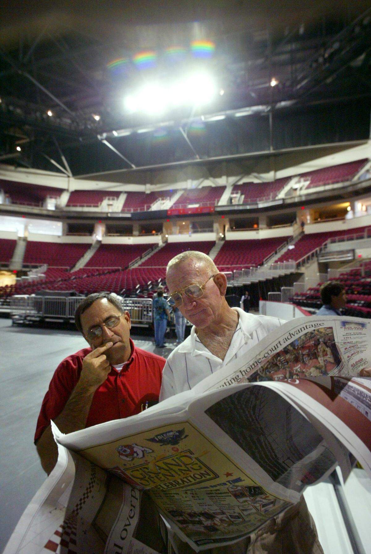 Pat Ricchiuti, left, and Red Estes, right, consult diagrams of the layout for the new Save Mart Center as they stand on the arena’s floor after a ribbong cutting ceremony on Monday, Oct. 27, 2003.