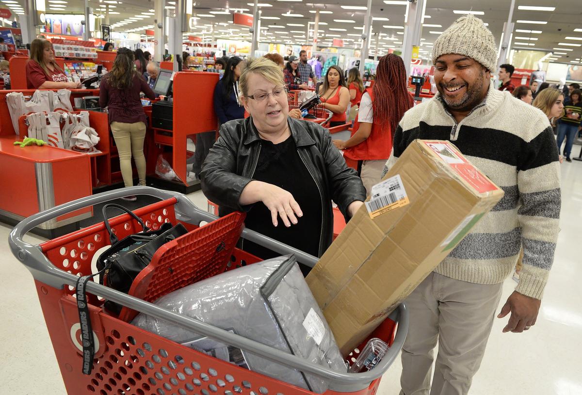 Cindy Tomik and Kittren Murphy of Fresno take inventory of their purchases at Target during the Black Friday shopping event at River Park in Fresno on Friday, Nov. 23, 2018.