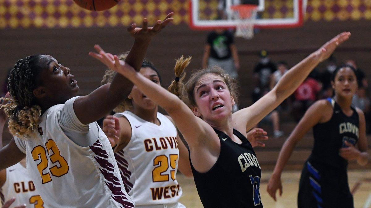 File photo of Clovis West’s Etoyah Montgomery, left, and Clovis’ Devin Miller, right, fight for the loose ball in the final minutes of the Central Section Open Division girls basketball championship Thursday, June 10, 2021 in Fresno.