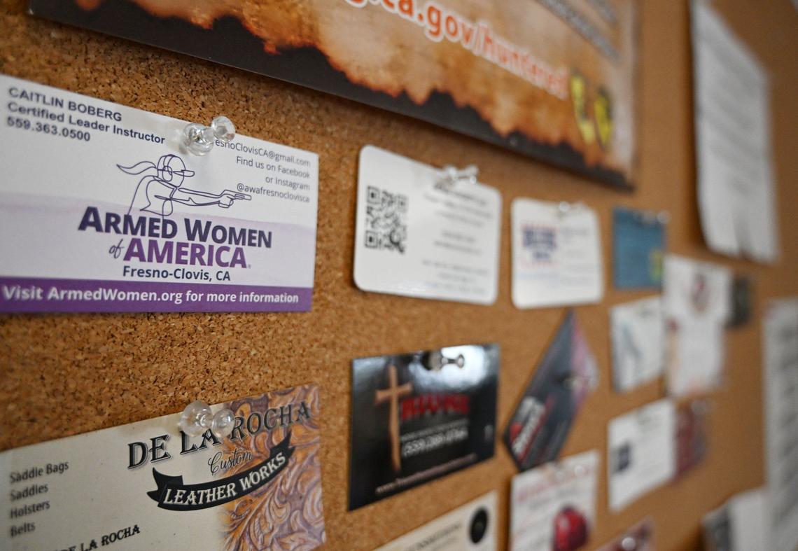 Business cards forr local contacts are seen on a bulletin boarda at Ryan Farrell’s South Gate Firearm Supply shop, showing the local network that as grown around his firearms business. Farrell is closing his shop on the last day of this month, citing high costs of doing business due to new state laws for selling firearms. Photographed Tuesday, Aug. 20, 2024 in Yosemite Lakes Park near Coarsegold, CA.