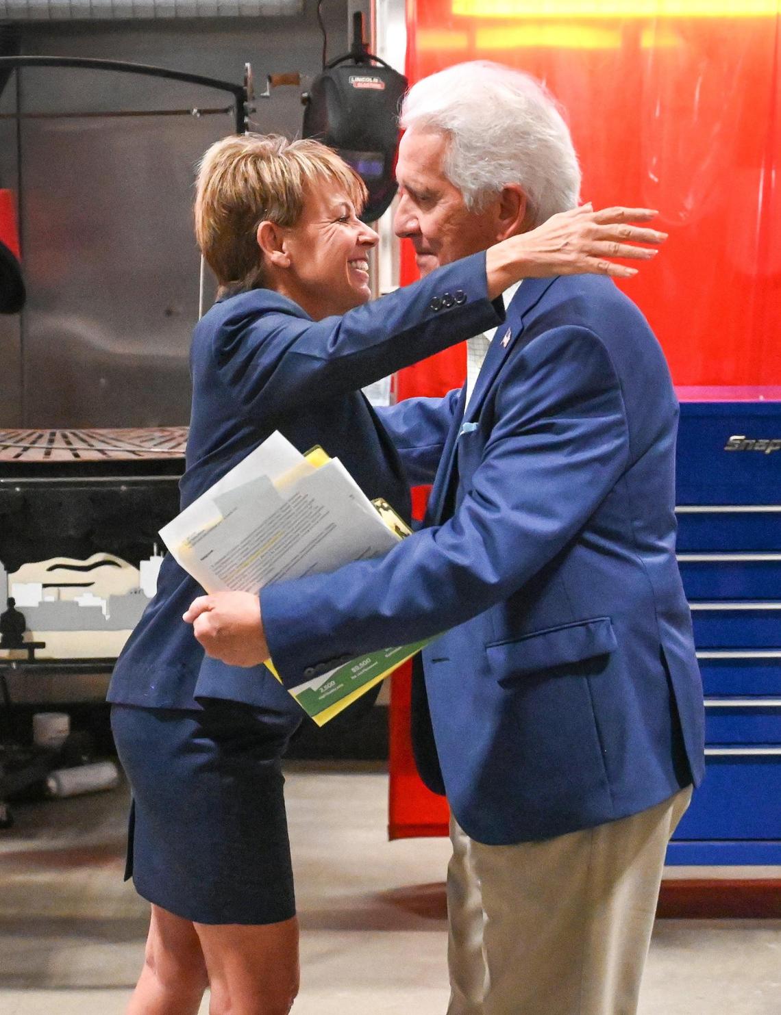 Lee Ann Eager, CEO/President of the Fresno County Economic Development Corporation, hugs Congressman Jim Costa during a press conference to announce new funding of $23 million through the American Rescue Plan Good Jobs Challenge awarded to the Fresno County Economic Development Corporation to develop and launch the project, at CTEC High School in Fresno on Thursday, Aug. 4, 2022.