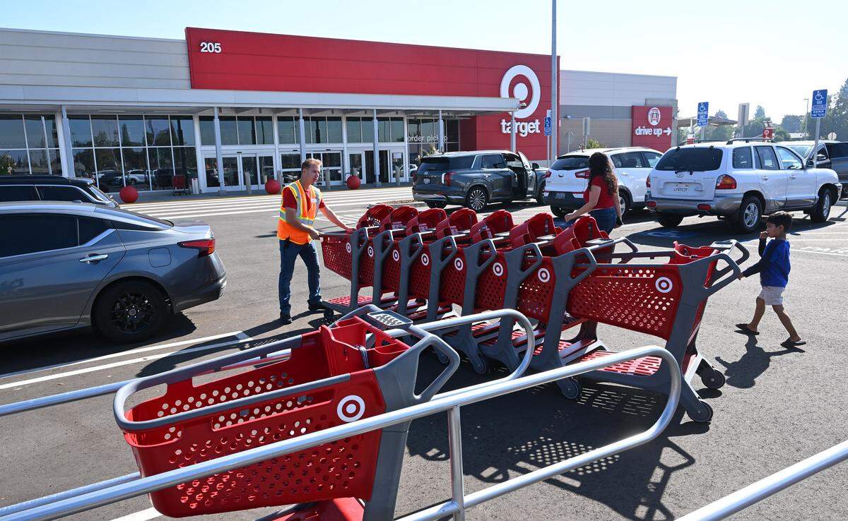 Shopping carts are collected as shoppers visit the new Target in the Fancher Creek Town Center Tuesday, Oct. 21, 2025 in Fresno.