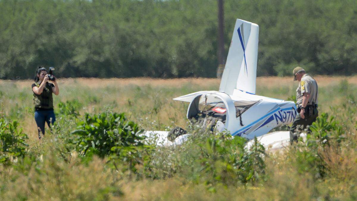 Investigators examine the scene of a small airplane crashed in a Madera County field on Thursday, April 25, 2019.