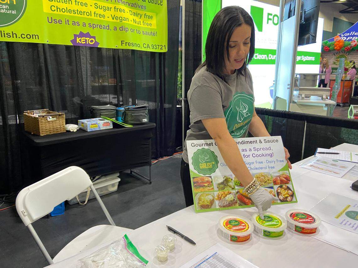 Karla Lugo of Fresno-based Garlish explains her garlic spread at the MADE Central California show. The company is also gearing up to open a sandwich shop in downtown Fresno.