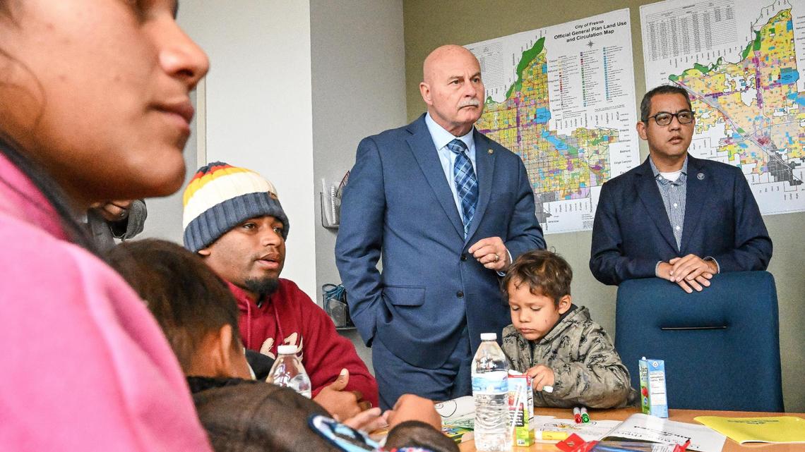 Fresno Mayor Jerry Dyer, center and City Councilmember Miguel Arias meet with asylum-seeking migrant families and individuals at Fresno City Hall on Friday, Feb. 2, 2024. The migrants are among a group from Venezuela and Peru who were sent by bus from Texas to Denver, and then on to Fresno, arriving the previous weekend.
