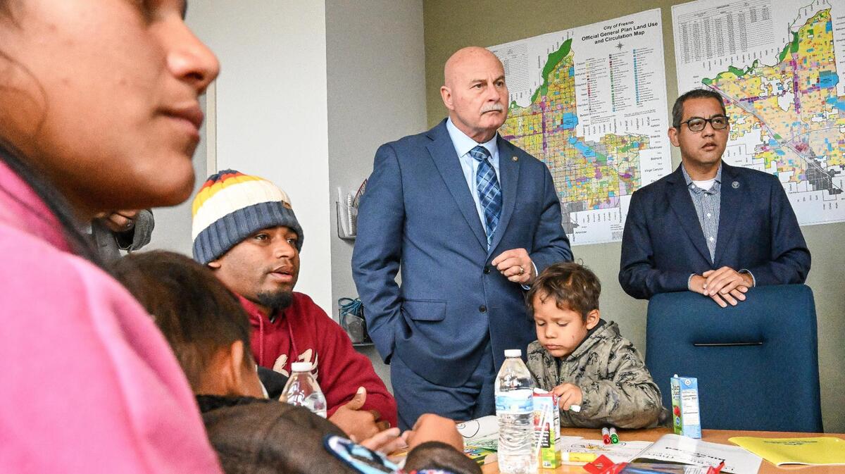 Fresno Mayor Jerry Dyer, center and City Councilmember Miguel Arias meet with asylum-seeking migrant families and individuals at Fresno City Hall on Friday, Feb. 2, 2024. The migrants are among a group from Venezuela and Peru who were sent by bus from Texas to Denver, and then on to Fresno, arriving the previous weekend.
