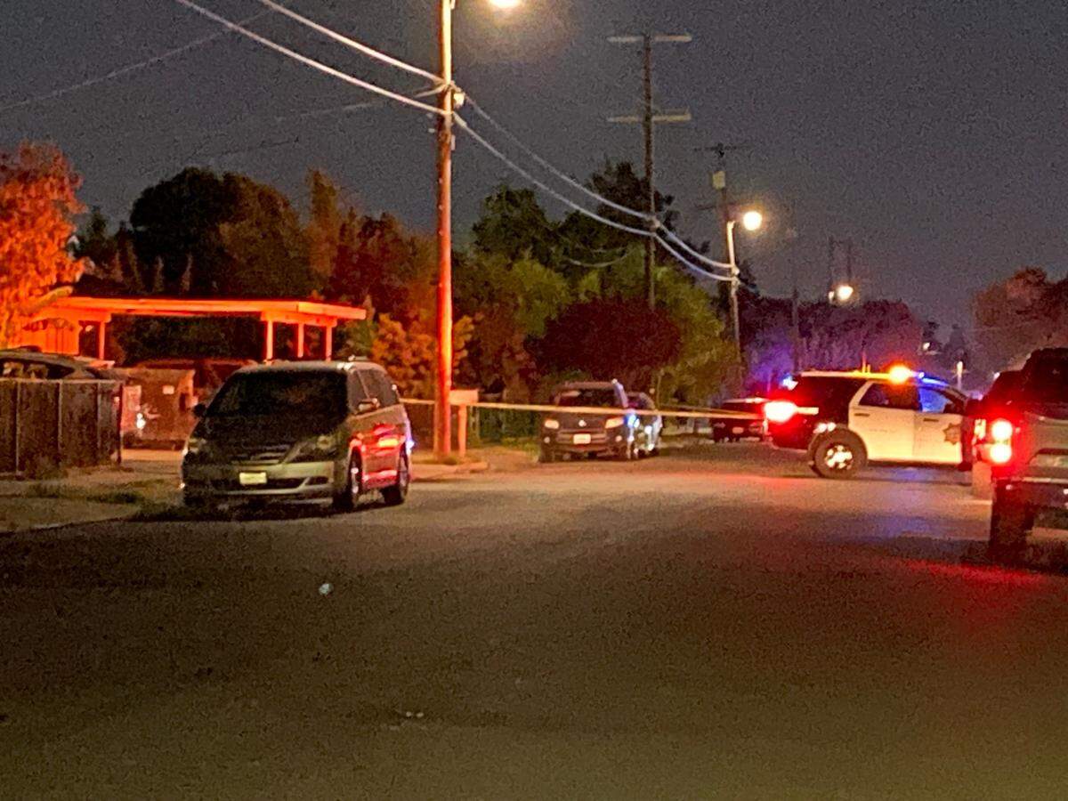 Police officers investigate a double shooting Thursday, July 18, 2024, near Cedar and Woodward avenues in Fresno, California.