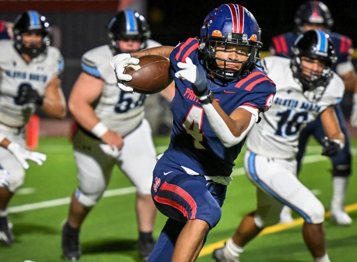 Memorial’s Syriss Fuller high-steps his way for a few yards against Clovis North during their game at San Joaquin Memorial on Friday, Aug. 23, 2024.