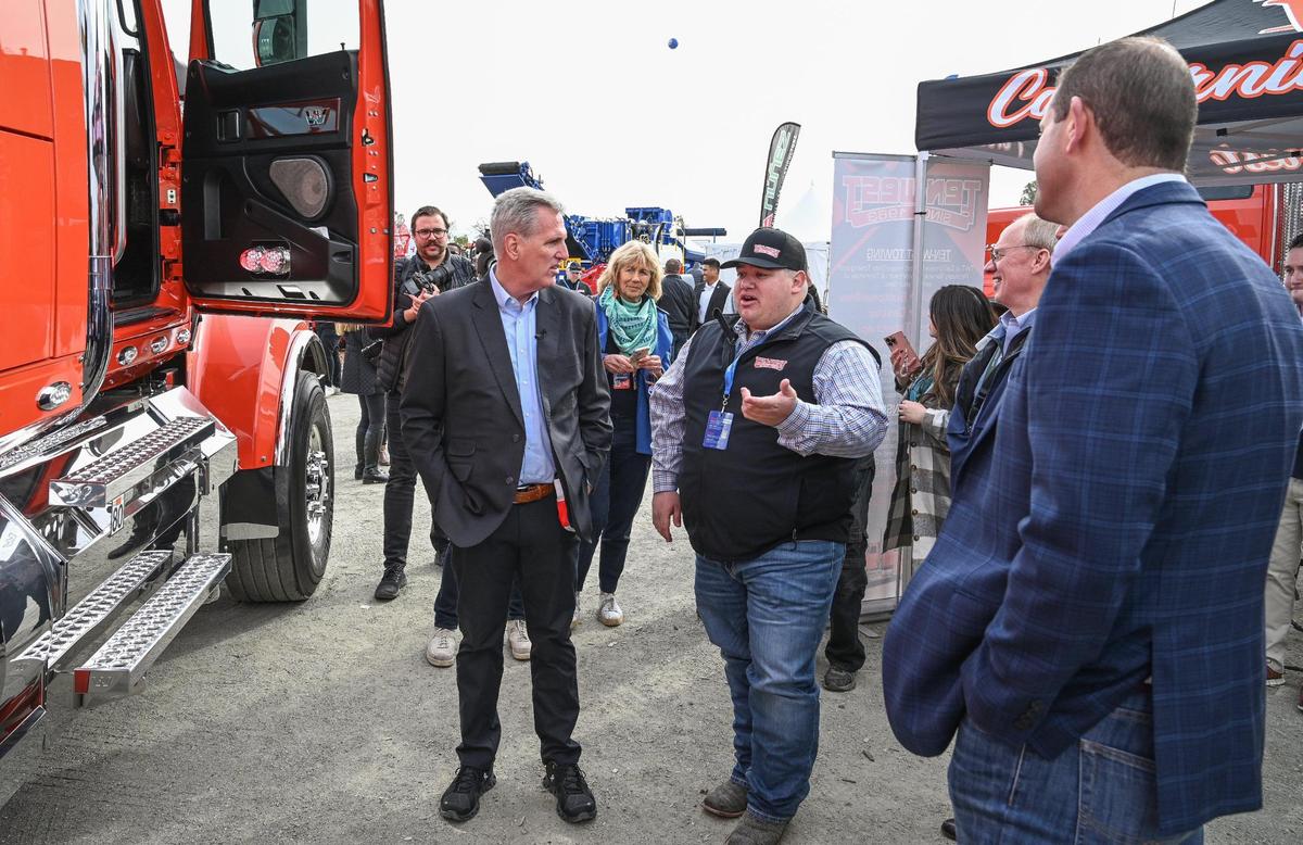 Speaker of the House, Republican Kevin McCarthy of Bakersfield, left, talks with a farm equipment seller while touring the World Ag Expo in Tulare with Valley Congressman David Valadao, right, during their opening ceremonies on Tuesday, Feb. 14, 2023.