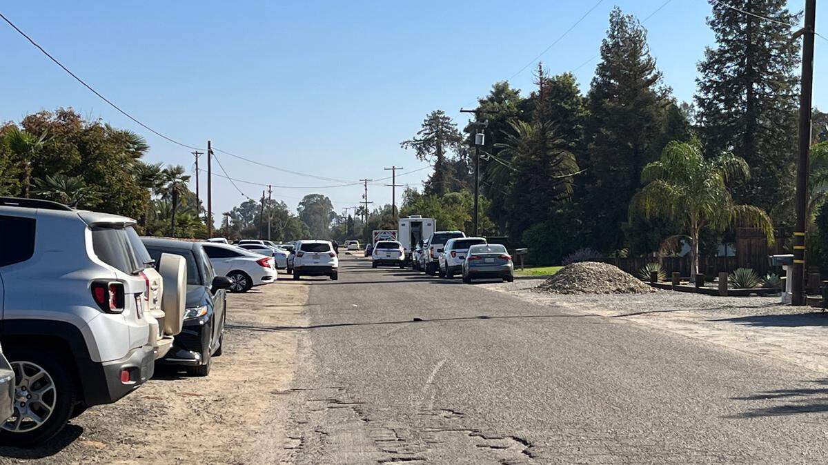 Dozens of cars were left on East Hedges Avenue off De Wolf Avenue after gunfire rang out Saturday, Oct. 29, 2022, at a Halloween party and one person was shot to death. Fresno County Sheriff’s Office homicide detectives are continuing their investigation.