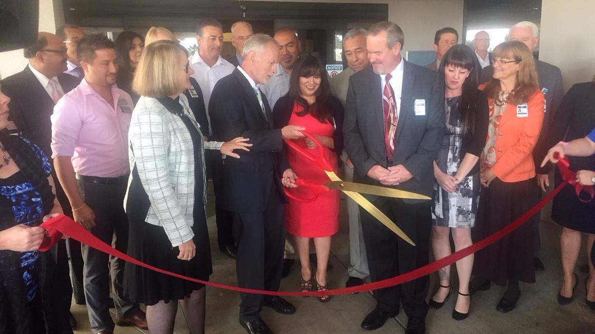 Tulare Local Health Care District chairman Kevin Northcraft, holding scissors, and fellow board members and Adventist Health officials prepare to cut the ribbon to open Tulare Regional Medical Center.