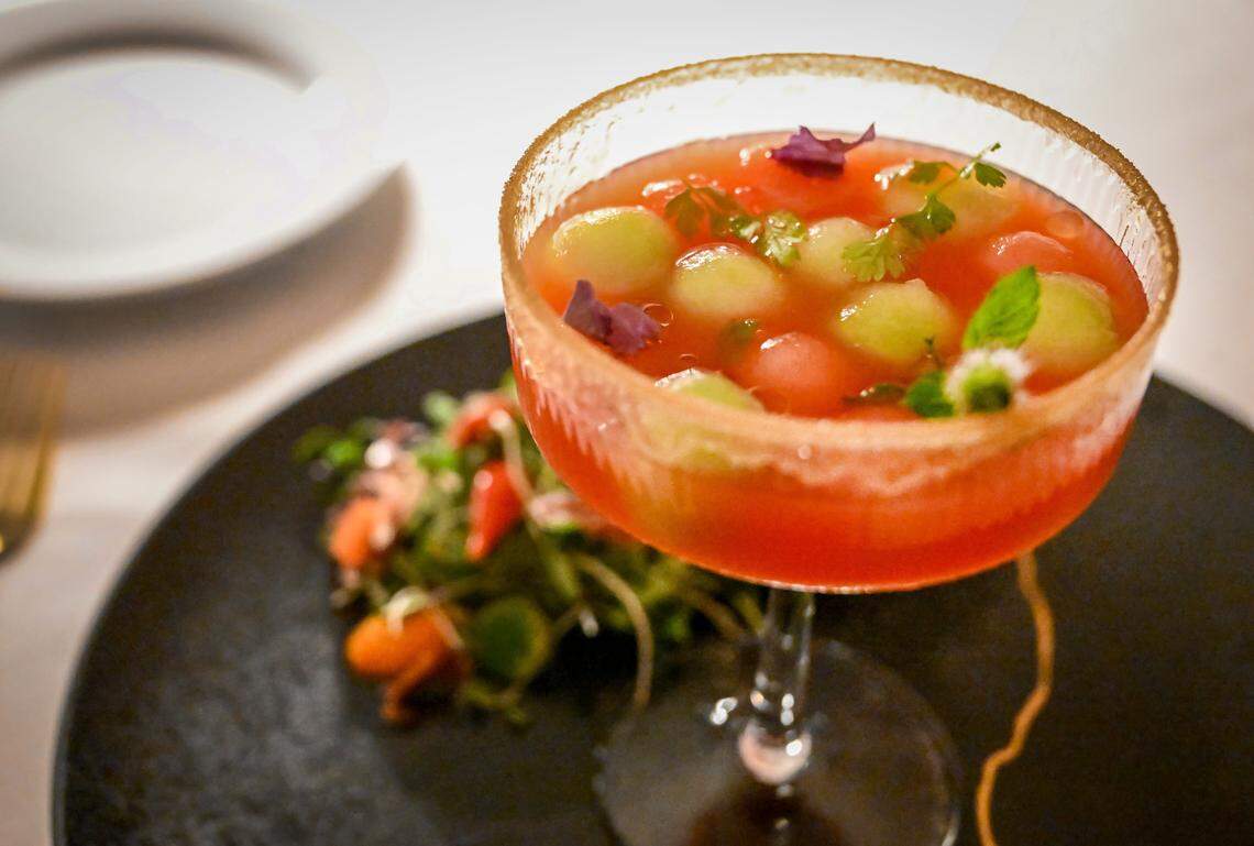 A watermelon consommé featuring rose water, watermelon spheres, basil caviar, mint and chili oil is displayed during a media event to promote The PM Lounge, a new members-only club that promises to bring high-level dining experiences and live entertainment to its guests.
