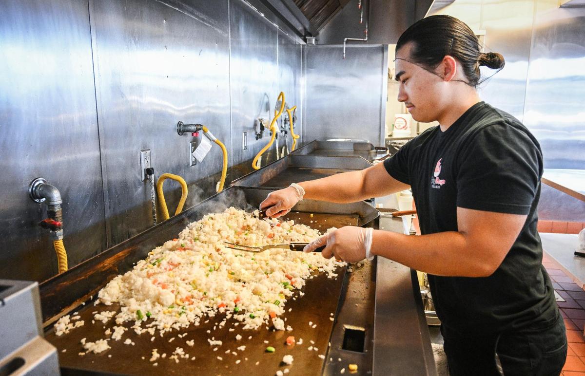 Pose Thao of Spicy Mayo Hibachi cooks a batch of bacon fried rice at their new restaurant on Shaw Avenue near West Avenue in Fresno on Tuesday, May 16, 2023.