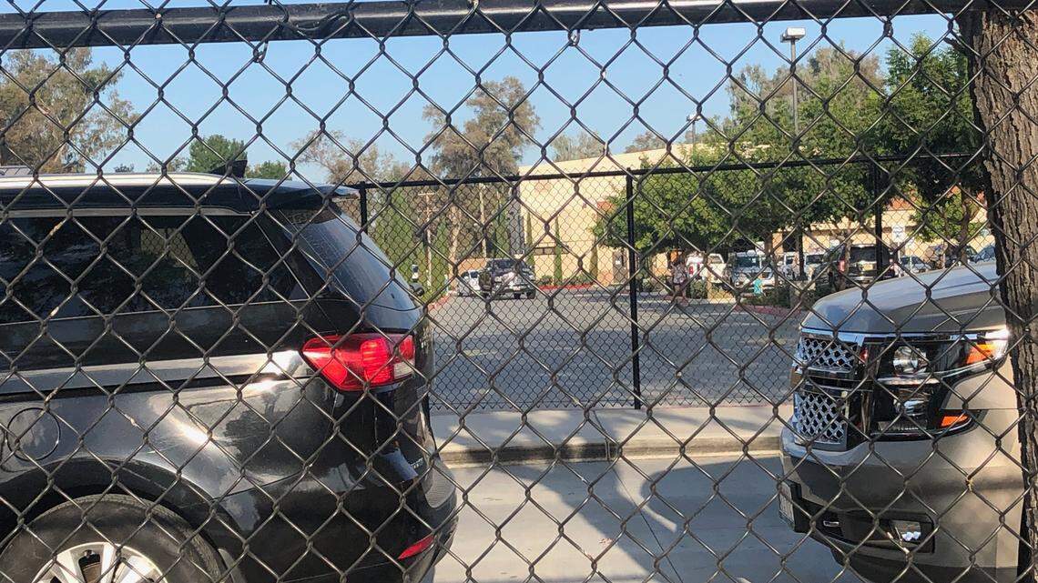 Cars fill the parking lot at Immanuel Schools in Reedley, California, on Friday, Aug. 14, 2020. The private school held in-person classes on Thursday in defiance of a state order that schools on the state’s watch list due to the coronavirus pandemic close campuses.