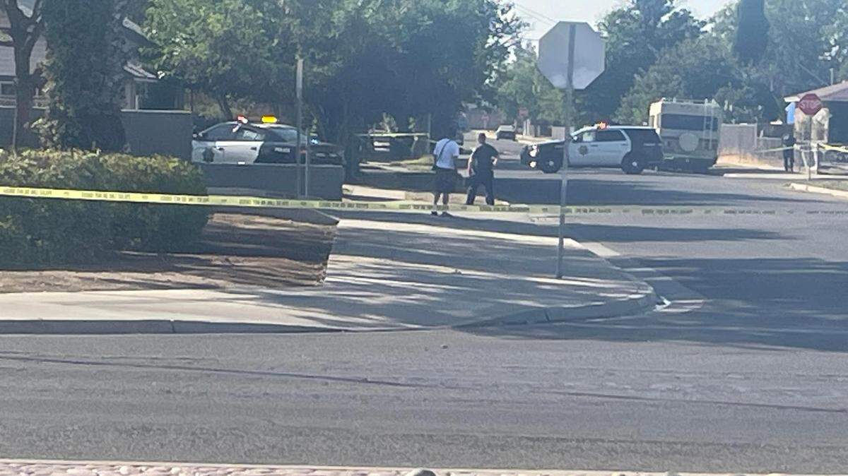 Fresno police surround a shooting scene near El Monte and Recreation avenues in southeast Fresno on Sunday morning, Oct. 8, 2023.
