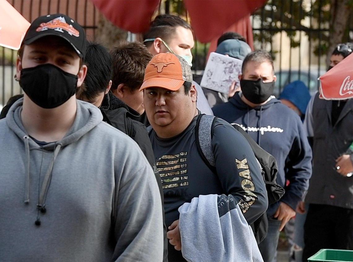 Fresno City College students line up for a free hot lunch, Nov. 18, 2021, during program that teams up the Ram Pantry and students in the university’s Food Service Management class in giving students studying to become chefs the opportunity to help out other students in need with food insecurities.