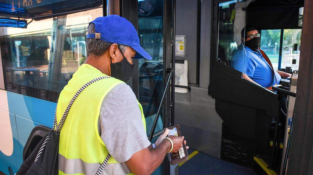 Yonas Paulos, of Fresno, who is visually impaired and relies on buses to get to his medical appointments, boards a Fresno Area Express bus in downtown Fresno on Friday, Aug. 28, 2020.
