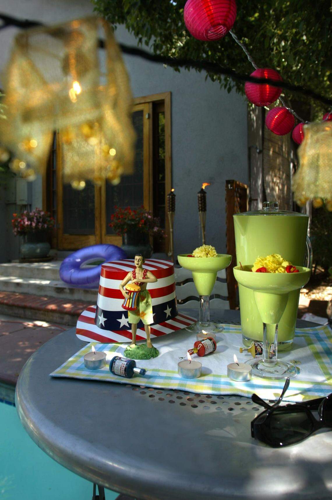 Holidays like the Fourth of July offer an opportunity to throw outdoor parties with non-traditional themes and decorations including bright-colored hanging lanterns.