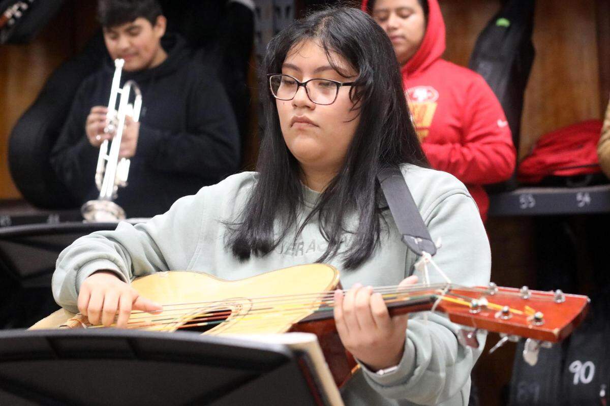 Orosi High School Mariachi Cardenal guitarrón player Allison Girón during the mariachi class on Wednesday, March 15, 2023.