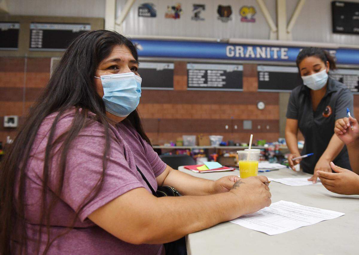 Tammy Walker, left, from Big Sandy Rancheria, talks about the help she and her family are receiving as evacuees from the Creek Fire seek services and shelter from the Red Cross and other agencies at Granite Ridge gymnasium Monday, Sept. 14, 2020 in Clovis.