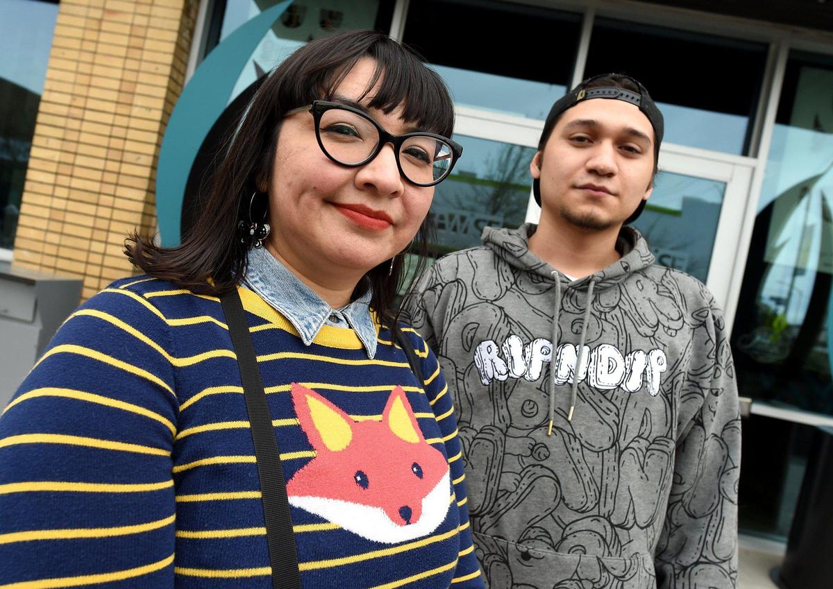 Miguel Hernandez, a former Bitwise apprentice who is now an online marketing analyst, walks with Emelia Guadarama, a current Bitwise apprentice, and Miguel Hernandez, a former Bitwise apprentice who is now an online marketing analyst, meet outside Bitwise. The program gives those who may not be able financially to enter the tech field an opportunity to learn the necessary skills and earning money while doing so.