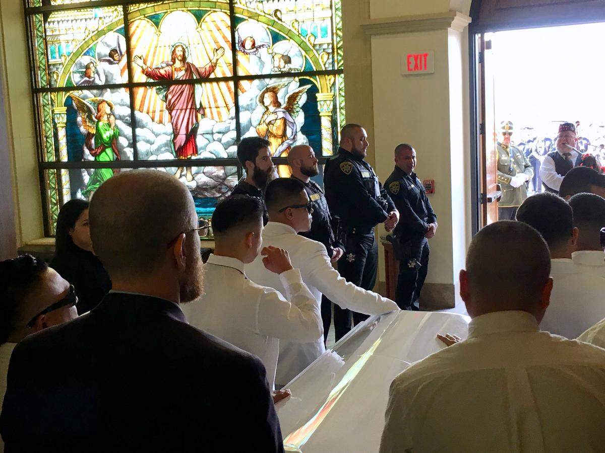 Pallbearers carry the casket of Lemoore Police Officer Jonathan Diaz out of Saint Peter Prince of the Apostles Catholic Church in Lemoore on Nov. 15, 2019.