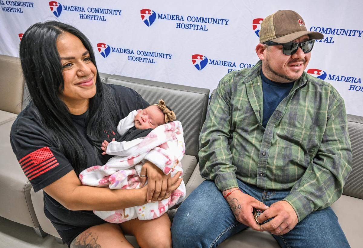 Rebeca Cervantes and her husband Javier Bautista sit with their baby, Haven Bautista Cervantes, who was delivered at Madera Community Hospital on September 8, 2025. The Madera couple said they would be unable to make it to Saint Agnes in Fresno in time so they rushed to the Madera hospital where hospital staff helped her deliver the baby.