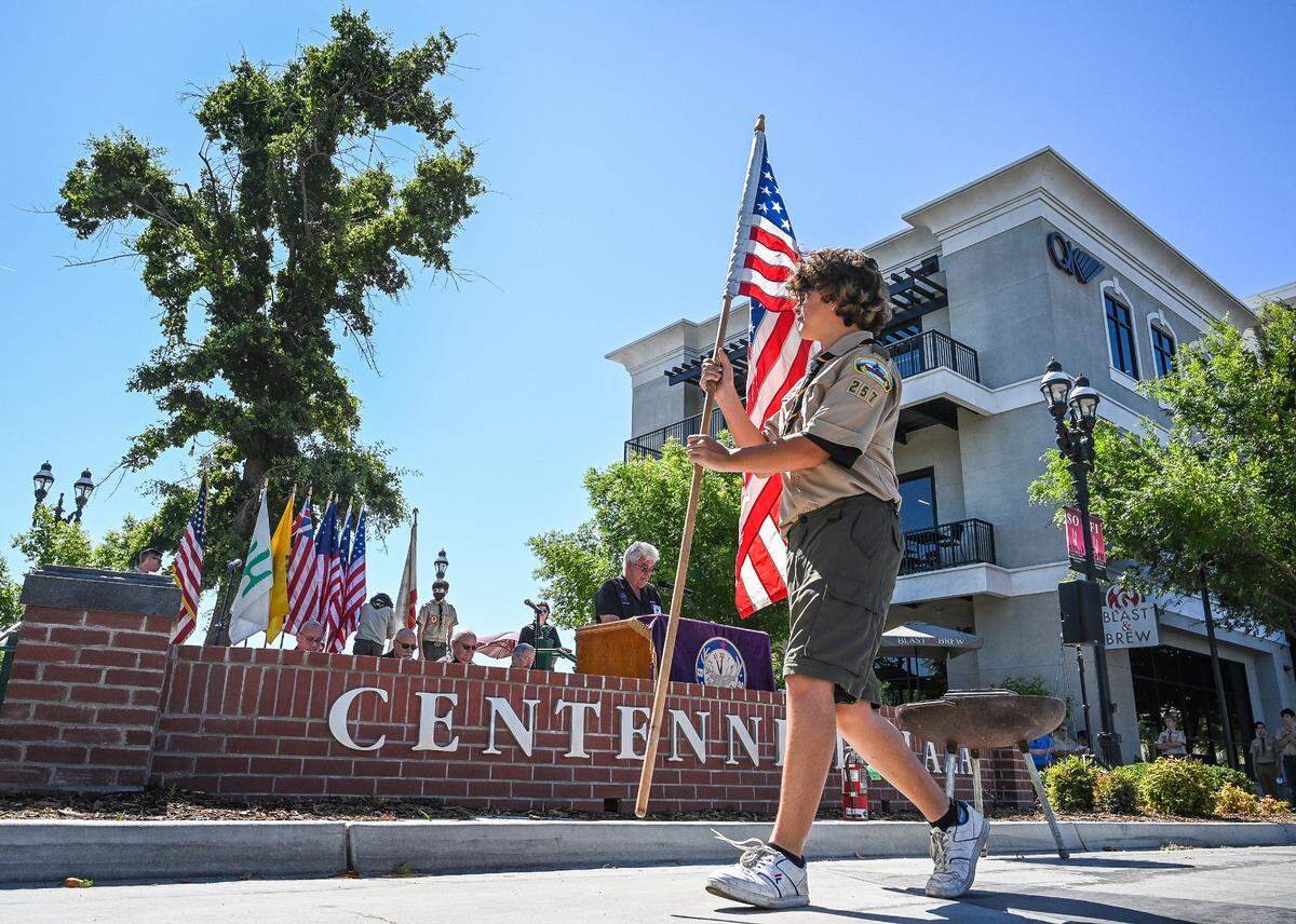 Alejandro Aburto of the Boy Scouts Troop 257 of Clovis carries the American flag during a Flag Day ceremony at Centennial Plaza in Clovis on Tuesday, June 14, 2022.