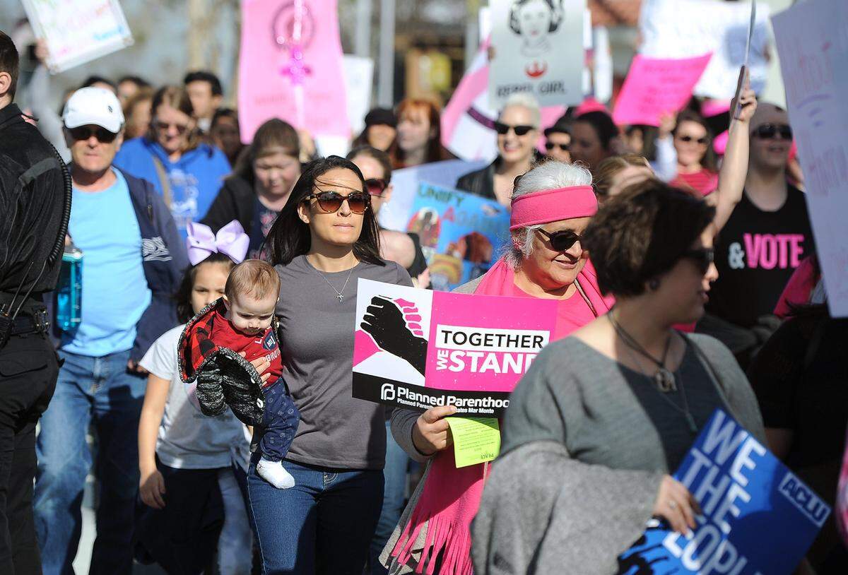 Marchers cross Nees Avenue at the third annual Women’s March, held Saturday, Jan. 19, 2019 in Fresno.