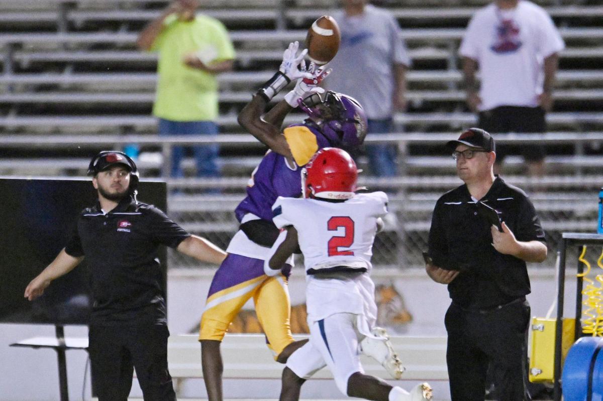 Lemoore’s Kiontre Harris makes the catch covered by Sanger’s Carlos Young, foreground, Friday, Sept. 8, 2023 in Lemoore. Sanger dominated Lemoore in the 42-13 win.