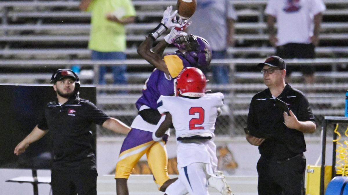 Lemoore’s Kiontre Harris makes the catch covered by Sanger’s Carlos Young, foreground, Friday, Sept. 8, 2023 in Lemoore. Sanger dominated Lemoore in the 42-13 win.