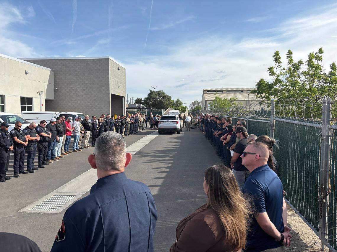 An assortment of emergency services members at the Tulare County Coroner’s Office in Tulare, California receive the body of a deputy who was shot and killed in the line of duty in Porterville on Thursday, April 9, 2026.
